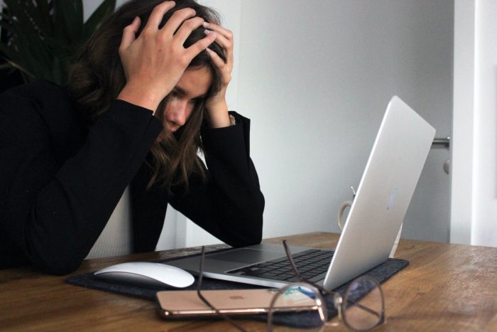 woman frustrated due to slow laptop woman frustrated due to slow laptop