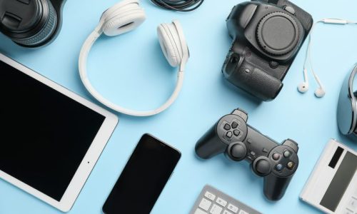 Different modern devices on color background